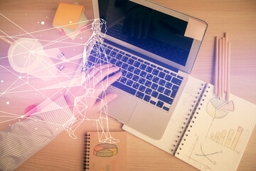 Double exposure of man's hands typing over computer keyboard and conceptual start up theme drawing....