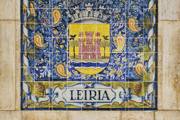 azulejos panel representing monuments and country scenes on the walls of Leiria station, Portugal..