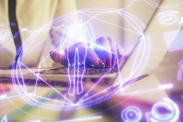 Double exposure of woman hands typing on computer and general theme hologram drawing. Education concept.