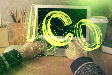 Double exposure of woman hands typing on computer and crypto market theme hologram drawing....