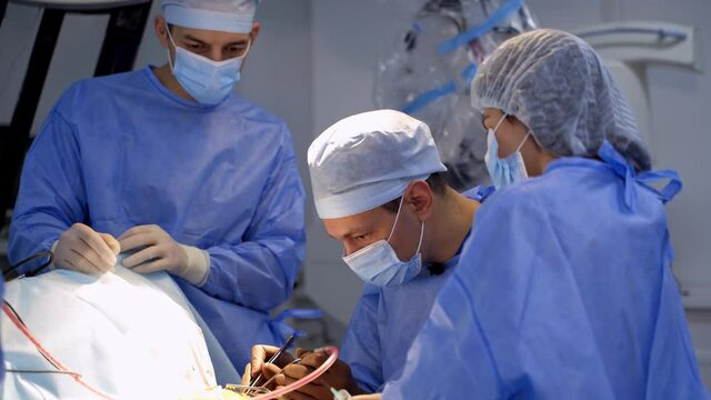 Neurosurgeons workgroup in emergency ward. Surgery specialists operation treatment.