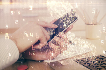 Double exposure of man's hands holding and using a digital device and tech theme hologram drawing. Technology concept.