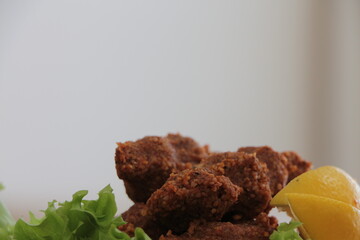 Cig kofte,  Chee kofta, raw meatball, one of the most important dishes of Turkish cuisine. Cig kofte with lettuce and lemon. Traditional Turkish Raw Meat.