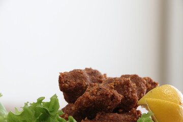 Cig kofte,  Chee kofta, raw meatball, one of the most important dishes of Turkish cuisine. Cig kofte with lettuce and lemon. Traditional Turkish Raw Meat.
