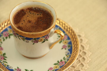 A cup of delicious Turkish coffee. Traditional Turkish Coffee. coffee in porcelain cup with blue decoration with Coffee foam. Close up. 