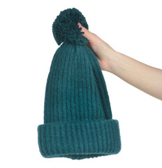 Green warm hat in hand on white background isolation