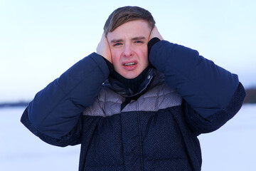 Portrait of handsome guy, young frozen man suffering freezing because of cold ice icy weather,...