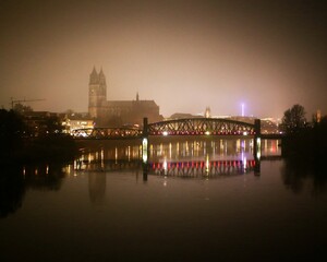 Misty view on Magdeburg and river Elbe. The text on the bridge says von hier aus noch viel weiter (even further from here)