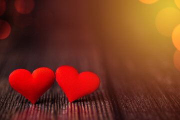 Valentine's Day background with two red hearts on a beautiful background with multicolored bokeh. Love concept. Festive background.