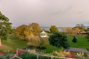 Fototapeta premium Blackrock, Dublin, Ireland, November 12, 2021:A view of Dublin Bay from Blackrock looking across Blackrock Part which features a Bands stand and landscaped gardens that lead to the coast line