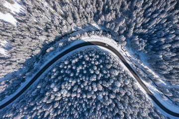 Natural winter landscape from air. Aerial view on the road and forest at the winter time. Winter...