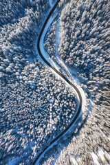 Natural winter landscape from air. Aerial view on the road and forest at the winter time. Winter...