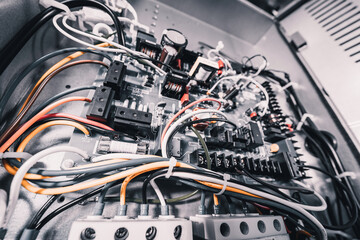 Open air conditioner unit with wires, pipes and electrical equipment