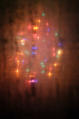 A Christmas tree through a foggy window 