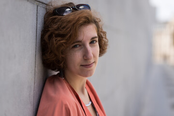 Fototapeta premium young woman standing against a wall