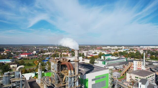 Smoke tower of industrial factory. Chimney smokestack emission.Refinery plant with pipes. Plant with smoke frow pipe and environmental pollution. Ecology concept and poor environment.
