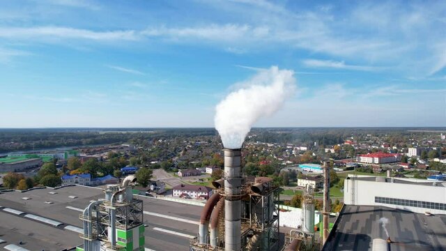 Smoke tower of industrial factory. Chimney smokestack emission.Refinery plant with pipes. Plant with smoke frow pipe and environmental pollution. Ecology concept and poor environment.
