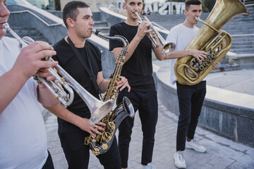 Young street music band play a lot of musical instruments
