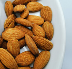 peeled almonds close up on white plate