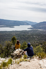 Two friends looking down to the Big Bear lake in California, USA