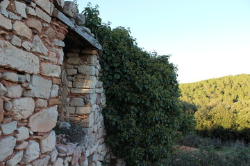 Fototapeta na wymiar Old stone building near the small village of Aiguafreda, Catalonia, Spain, Europe. Aiguafreda de Dalt