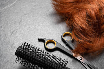 Hairdressing salon concept abstract background. Redhead women wig and comb and scissors on the hairdresser table background.