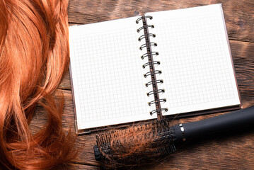 Hairdresser notes template. Hair care tips concept. Empty blank page notebook, hair comb and wig on...