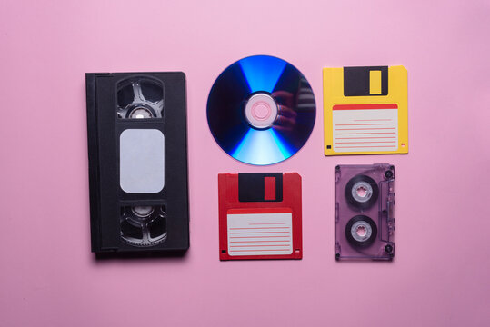 VHS, audio cassette, compact disk and floppy disk background.