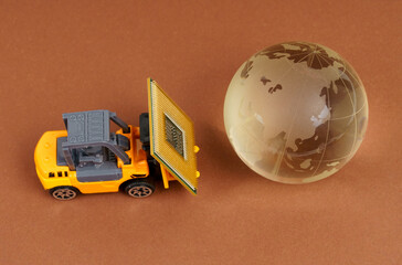 Technology and globalization concept. A toy loader brings a processor to the planet.
