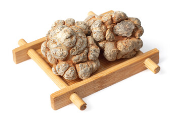 Dried herb, notoginseng roots in the bamboo plate, isolated on white background