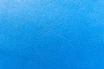 Horizontal background of blue rippled paper. Texture of rough blue paper