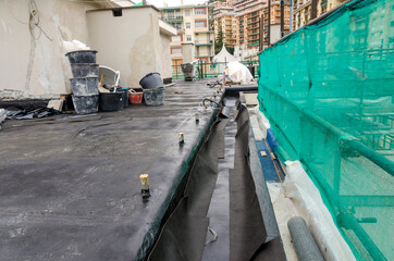 laying of waterproofing sheathing  and insulation during the renovation of a roof in Italy - 477009901