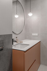 Modern minimalist bathroom interior design with grey stone tiles and terracotta furniture