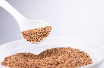 Buckwheat. Healthy food. Buckwheat spoon on white background