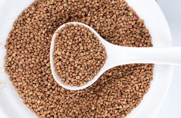 Buckwheat close-up. Healthy food. Buckwheat spoon on white background