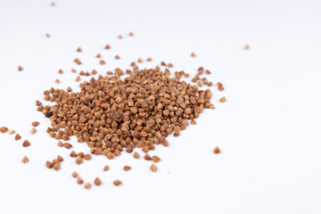 Pile of buckwheat on white background. Buckwheat seeds isolated on white background 