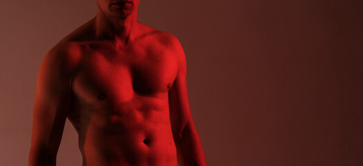 Strong man body. Strong body. Fintess concept. Fit male. Model. Neon light. Studio. Energy. 