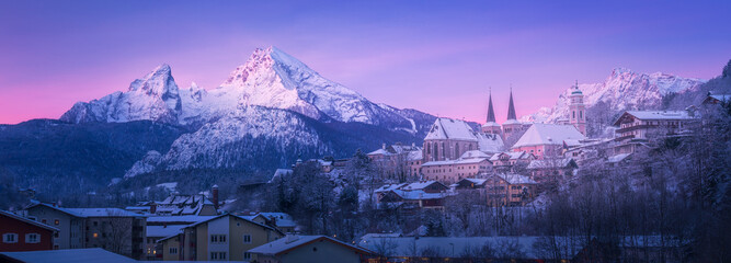 Berchtesgaden cityscape winter panorama with Mount Watzmann in the background on a cold snowy winter morning just before sunrise.