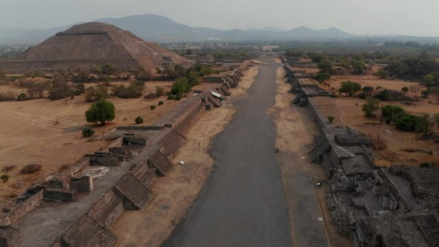 Birds eye view of Avenue of Dead and Pyramid of Sun in Teotihuacan complex, Mexico. Amazing drone view of travel destination and unesco world heritage with Temple of Sun in valley near Mexico City