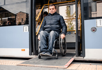 Fototapeta na wymiar Person with a physical disability exits public transport with an accessible ramp.