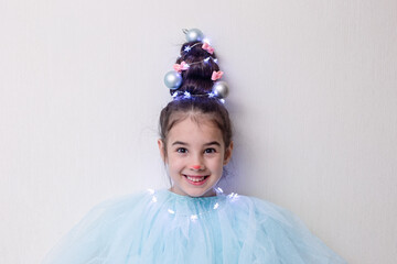 Portrait of funny girl with a hairstyle in the form of a Christmas tree