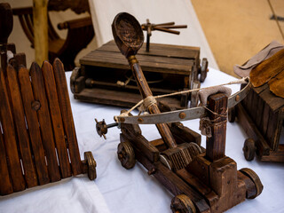 small wooden catapult model, miniature reproduction of medieval siege weapon
