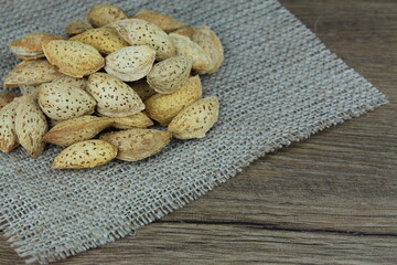 ALMONDS ON  WOODEN BACKGROUND