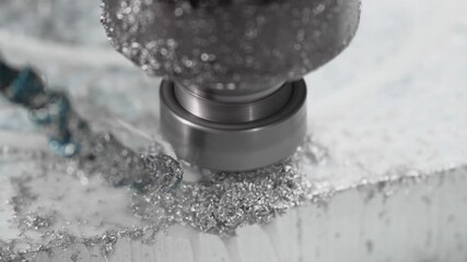 The CNC drill bit drills a hole in a flood aliminium shape in a circular motion. High technologies in metalworking