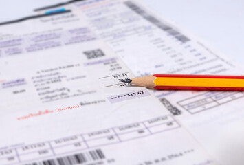 Utility energy bill with pencil blurred background