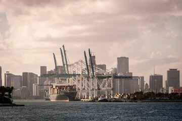 cargo ship unloading during sunset at Miami harbour