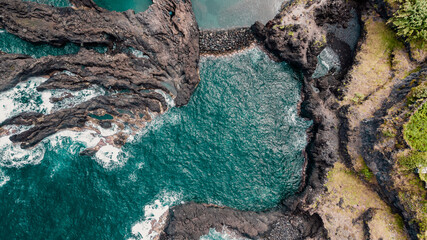Atlantic ocean coastline with cliffs rocks and turquoise waves. Madeira island, Portugal. Aerial drone photography. Panoramic landscape. Sea background.