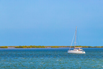 Panorama landscape view Holbox island turquoise water and boats Mexico.