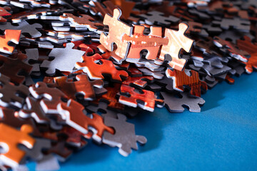 Mixed Peaces of a Colorful Jigsaw Puzzle Lie on the Blue Background - Strategy and Solving Problem Concept