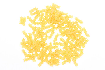 A Heap of Uncooked Fusilli Pasta Scattered on White Table. Raw and Dry Macaroni. Unhealthy and Fat Food. Italian Culture